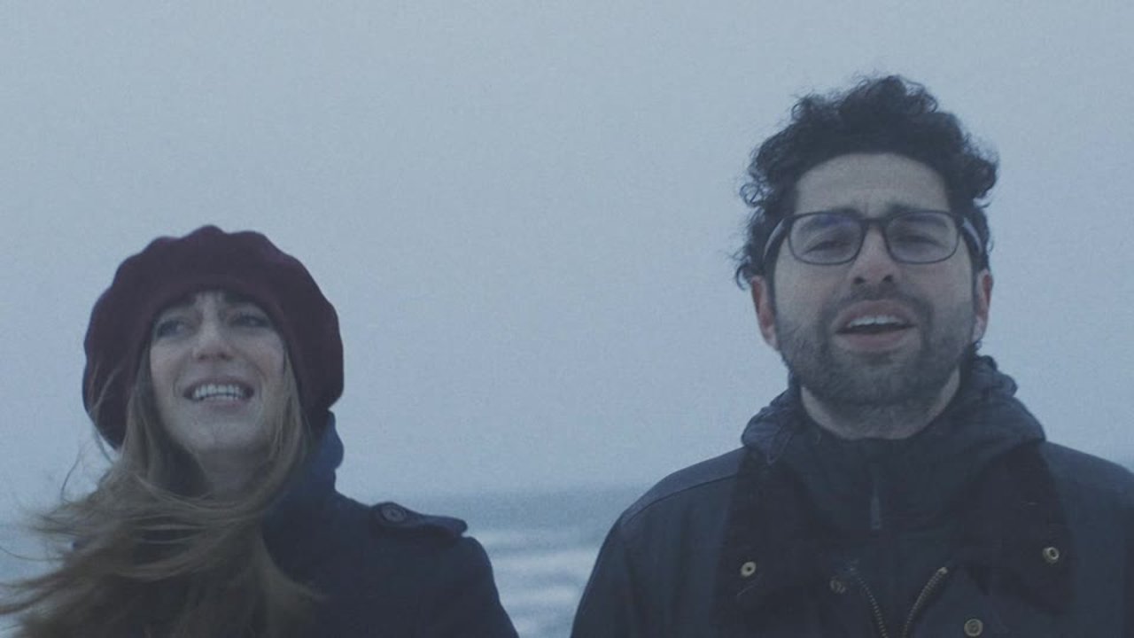 Two singers on a windswept beach